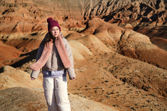 Woman in winter gear on rocky terrain
