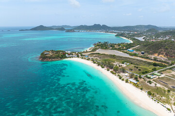 Aerial view of a white sand beach and coral reef