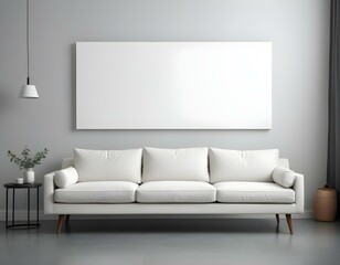 A white sofa with gray cushions in a minimalist living room setting, with a large blank white canvas hanging above the wall.