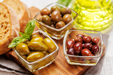 An assortment of various olives presented in a bowl, showcasing different colors, textures, and flavors