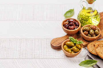 An assortment of various olives presented in a bowl, showcasing different colors, textures, and flavors