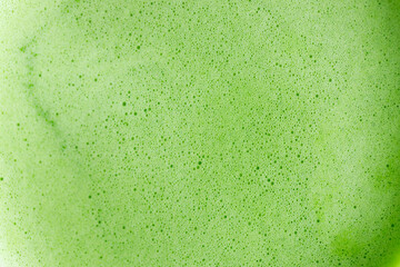Closeup of fresh matcha tea froth, green tea. Selective focus.
