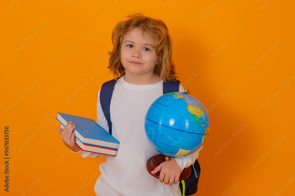 Poster knowledge day. school child with world globe and book. portrait of school boy isolated on yellow stu