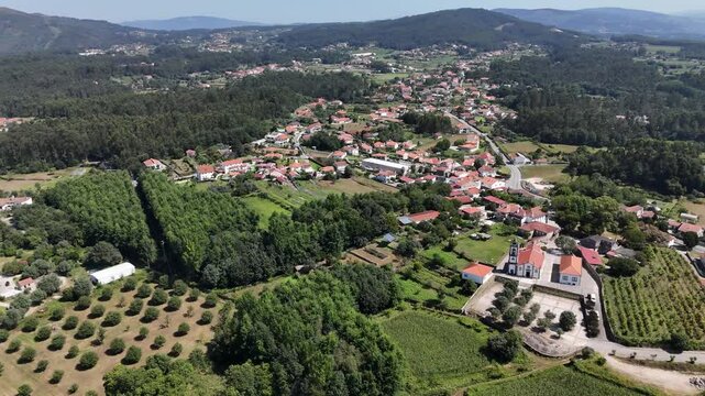 Aerial - Igreja Paroquial de Freixo, lush farmlands, hills, and village homes