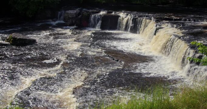 Wide side on shot of the upper falls at Aysgarth falls on the river ure, Yorkshire dales