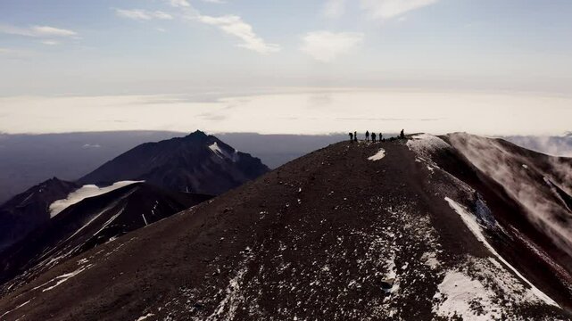 A group of people on top of the Avachinsky volcano