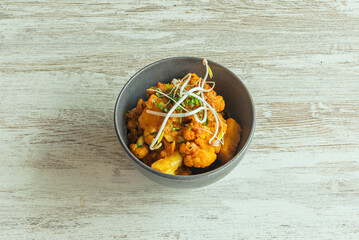 A bowl with a delicious Hindu recipe with aloo gobi cauliflower