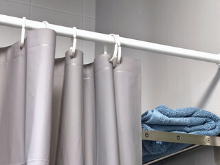Curtains with waterproof plastic rails divide the shower area.
