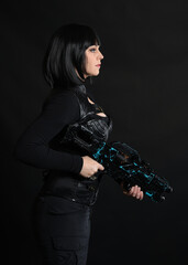 Close up portrait of beautiful black female model wearing black sci fi futuristic dystopian leather bodysuit costume. holding gun weapon. isolated dark studio background moody silhouette.