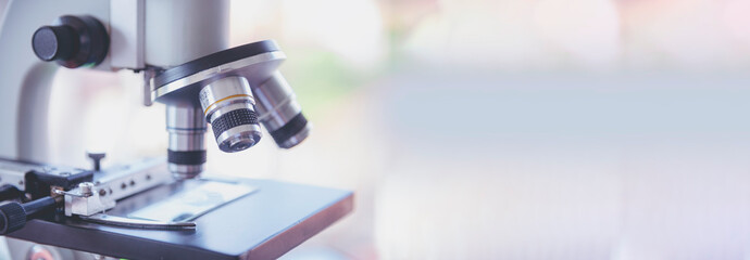 Banner Science microscope equipment in biology chemical laboratory. Scientific experiment Microscope on Lab table microbiology equipment. Banner Chemistry objects on lab background with copy space