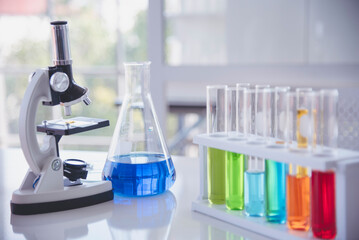 Science laboratory chemistry test science lab with microscope, glass tubes, chemical beaker white table scientific background. Colorful Liquid biology laboratory chemical fluid scientist experiment