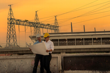 Two men engineer look at blueprint architecture building contractor design in modern city development. Males engineer holding project planing partner teamwork. Man meeting together construction site