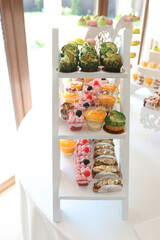 A sweet dessert table of mousses decorated with berries.