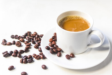cup of coffee and coffee beans on white background