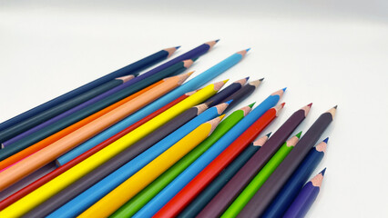 Fototapeta premium Colorful sharpened pencils are lined up on the table.