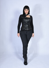 Full length portrait of beautiful black female model with short black hair wearing sci fi...