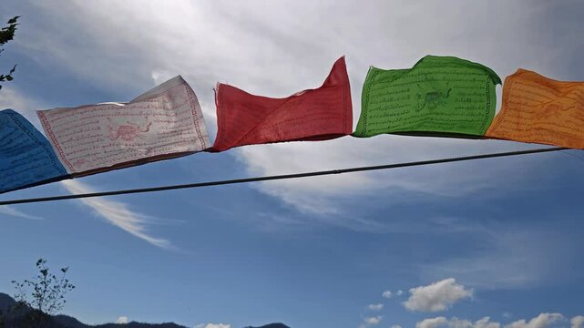 Video of Religious tibetan buddhist prayer flags on sky background.