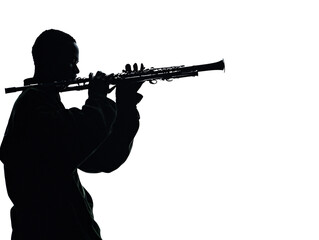 a silhouette of a man playing a flute
