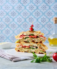 Breakfast, zucchini waffles with cucumber, shrimp, tomato and sauce filling on a gray concrete background. Savory waffle recipes.