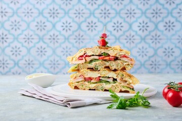 Breakfast, zucchini waffles with cucumber, shrimp, tomato and sauce filling on a gray concrete background. Savory waffle recipes.