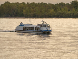 A river passenger vessel with a water jet engine sailing along the river