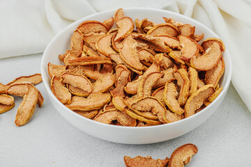 Dry pieces of apple in a bowl. Healthy food diet, vegan lifestyle, lose weight concept