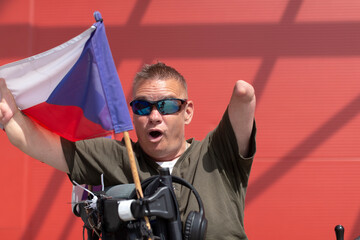 A joyful person waves the Czech flag, proudly showcasing their spirit in a vibrant, energetic...