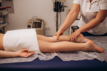 Fototapeta premium Physiotherapist working with little girl in rehabilitation center
