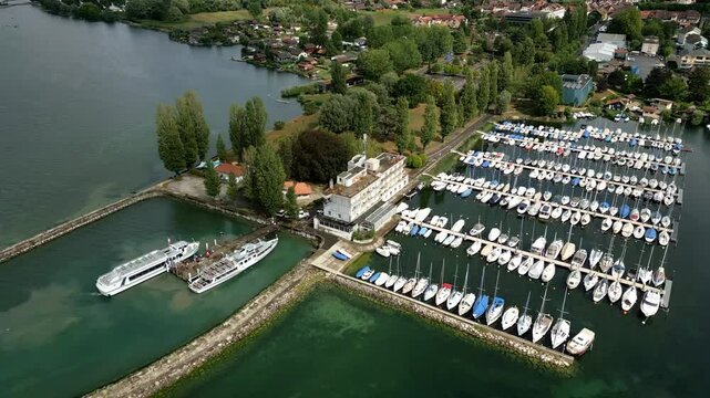 Push out drone shot of the port marina of Estavayer-le-Lac in the canton of Fribourg in Switzerland with the Lake Neuchatel.