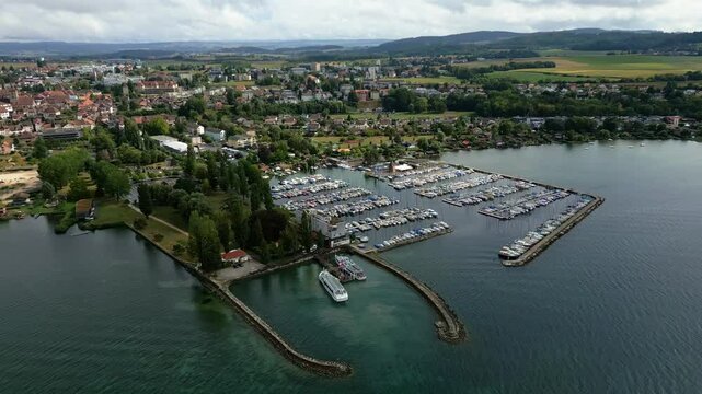 Tilt down drone shot of the port of Estavayer-le-Lac in the canton of Fribourg in Switzerland with the Lake Neuchatel.