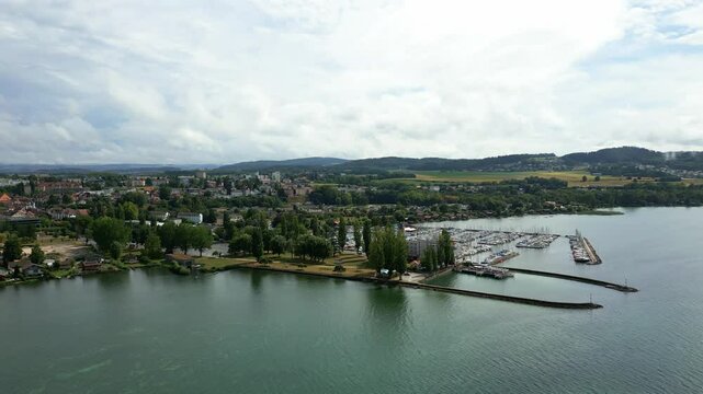 Push in drone shot of the port of Estavayer-le-Lac in the canton of Fribourg in Switzerland with the Lake Neuchatel.