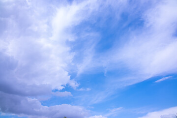 Clouds against the blue sky close-up. Changes in weather during the rainy season. Thunderclouds, approaching storm.