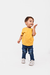 Portrait of a two-year-old boy kissing the air on white background