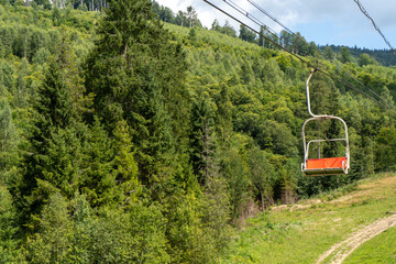 Fototapeta premium Cableway to top of Carpathian Mountain peak. Hills forest. Nature summer