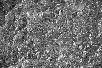 Processed collage of shiny metal silver gray foil crumpled packaging material texture