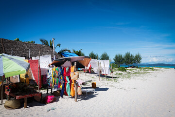 Exploring local souvenirs on Nosy Iranja Island in Madagascar with vibrant beach stalls and beautiful coastal views