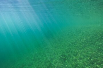 Fototapeta premium Underwater photo, rays of sun penetrate the water at the quarry of Lake Rummu.