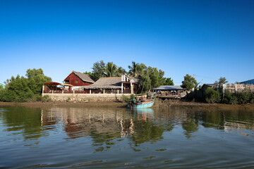 Fototapeta premium A tranquil village by the river in Morondava, Madagascar, showcasing local life and picturesque scenery during the day