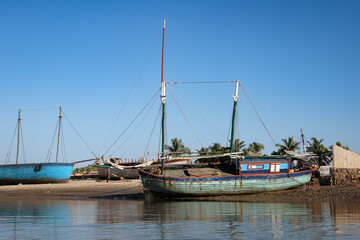 Traditional fishing boats moored by the river in Morondava, Madagascar during a clear sunny day