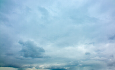 Rain clouds over a mountain range in the distance. Change of weather in the rainy season. Thunderclouds, an approaching storm.