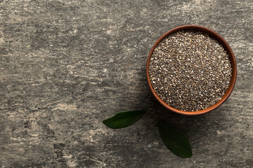 Chia seeds in bowl on colored background. Healthy Salvia hispanica in small bowl. Healthy superfood