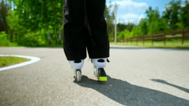 Father and daughter ride on roller skates. Girl learning to roller skate, and falls. Dad teaches daughter to ride on rollers