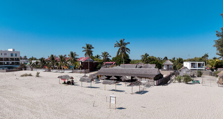 Aerial view of Morondava Village in Madagascar showcasing sandy beaches and local huts under clear skies