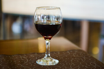 A full glass of wine on the table in the restaurant