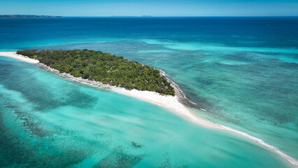 Aerial view of Nosy Iranja Island showcasing turquoise waters and lush greenery in Madagascar under clear skies