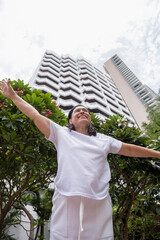 woman in white t-shirt standing on tropical plants, tshirt mockup