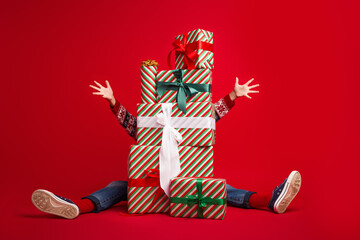 Full size photo of cute little boy hide behind present pile celebrate new year wear knitted outfit...