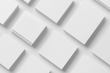 Obraz premium A closeup of white rectangle poster mockups laying diagonally on a light grey concrete background. View from the top.