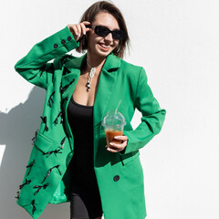 Happy beautiful young fashion woman model with smile in trendy urban clothes with green blazer...