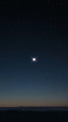 A bright star is shining in the night sky. The sky is dark and the stars are scattered all over